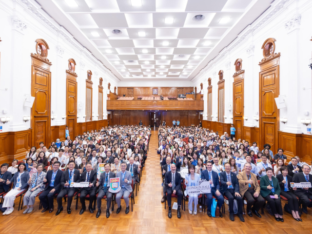 Four speakers engaged in a group discussion on stage 